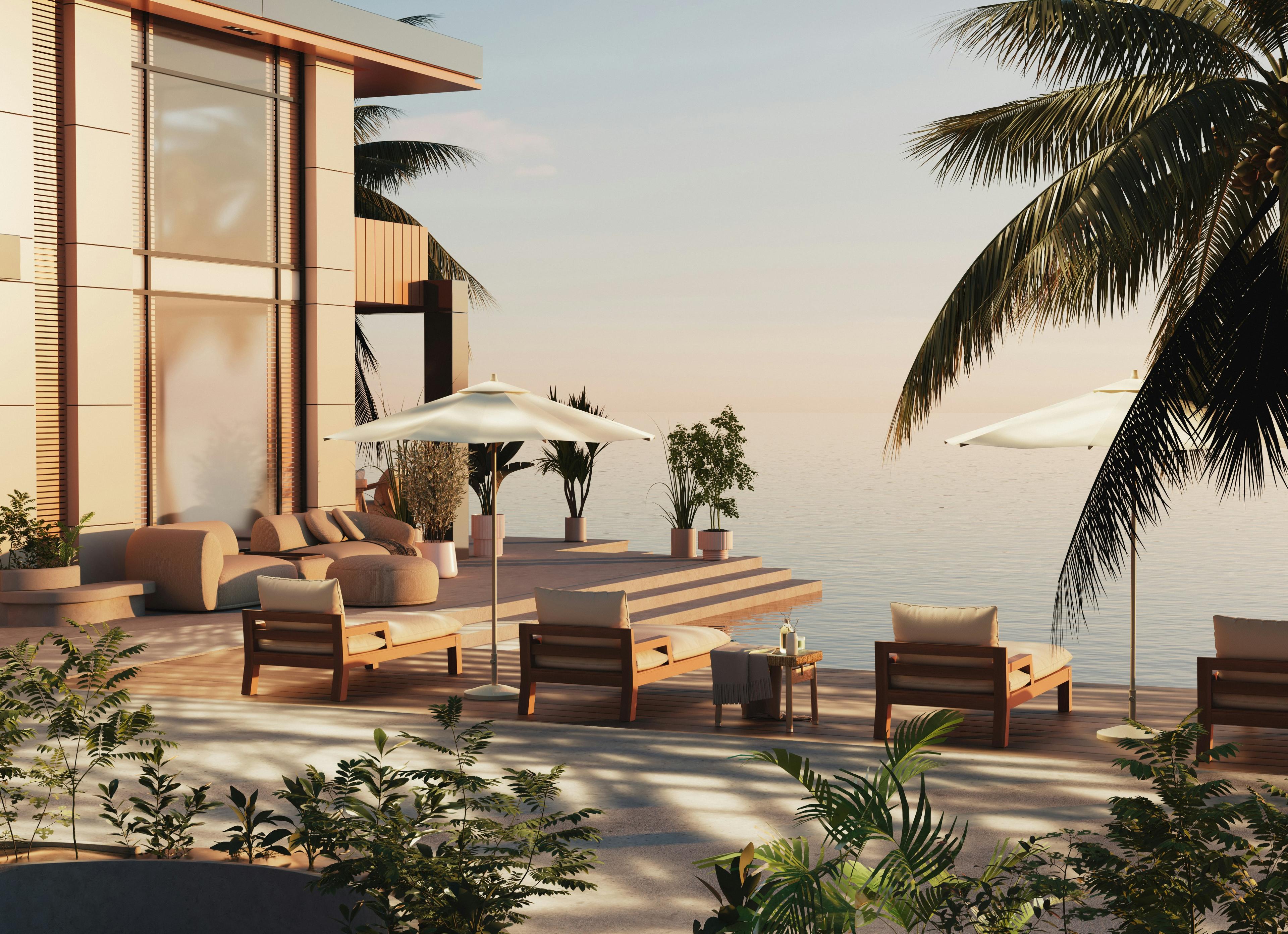 Luxury beachfront villa with glass doors opening to an ocean deck
